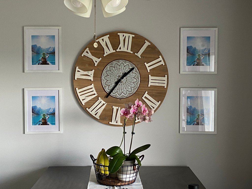 Mounted 4 pictures around a large wall clock